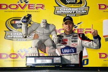 DOVER, DE - SEPTEMBER 27:  Jimmie Johnson, driver of the #48 Lowe's Chevrolet, celebrates with the trophy  in victory lane after winning the NASCAR Sprint Cup Series AAA 400 at Dover International Speedway on September 27, 2009 in Dover, Delaware.  (Photo