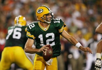 GREEN BAY, WI - SEPTEMBER 13: Aaron Rodgers #12 of the Green Bay Packers rolls out to find a receiver against the Chicago Bears on September 13, 2009 at Lambeau Field in Green Bay, Wisconsin. The Packers defeated the Bears 21-15. (Photo by Jonathan Daniel