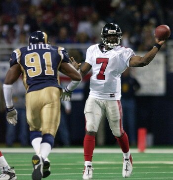 6 Jan 2002: Quarterback Michael Vick #7 of  the Atlanta Falcons sneaks a pass off before being tackled by Leonard Little #91 of the St.Louis Rams at the Dome at America's Center in St. Louis, Missouri.The St. Louis Rams beat the Atlanta Falcons 31-13.  DI