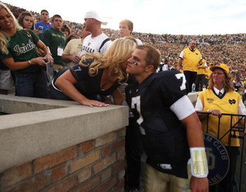 SOUTH BEND, IN - SEPTEMBER 19: Jimmy Clausen #7 of the Notre Dame Fighting Irish gets a hug from a relative after a win over the Michigan State Spartans on September 19, 2009 at Notre Dame Stadium in South Bend, Indiana. Notre Dame defeated Michigan State