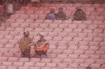 CLEVELAND, OH - DECEMBER 16:  Fans watch the action from the stands in a snowstorm in the 1st quarter during the game between the Cleveland Browns against the Buffalo Bills at Cleveland Browns Stadium on December 16, 2007 in Cleveland, Ohio. (Photo by Sco