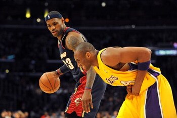 LOS ANGELES, CA - JANUARY 19:  LeBron James #23 of the Cleveland Cavaliers drives the ball against  Kobe Bryant #24 of the Los Angeles Lakers as Kobe  hunches over after he injures his hand during the first quarter at Staples Center on January 19, 2009 in