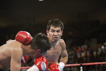 Las Vegas - June 22:  Marco Antonio Barrera (right) hits Erik Morales during the World Featherweight Championship fight at the MGM Grand Hotel/Casino in Las Vegas, Nevada on June 22, 2002.  Barrera defeated Morales by unanimous decision in 12 rounds and i