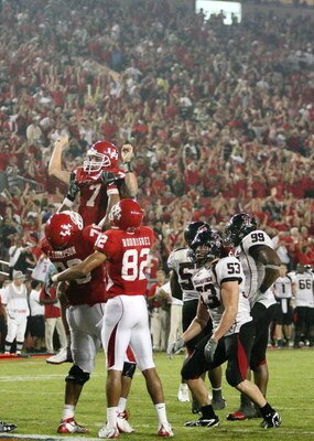 HOUSTON - SEPTEMBER 26: Quarterback Case Keenum #7 of the Houston Cougars is lifted in the air after Kennum scored a 4 yard touchdown run to give the Cougars a 29 to 28 win over the Texas Tech Red Raiders at Robertson Stadium on September 26, 2009 in Hous