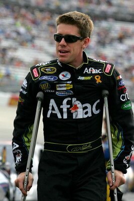 DOVER, DE - SEPTEMBER 27:  Carl Edwards, driver of the #99 Aflac Ford, walks on crutches to his car before the NASCAR Sprint Cup Series AAA 400 at Dover International Speedway on September 27, 2009 in Dover, Delaware.  (Photo by Todd Warshaw/Getty Images 
