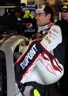 LOUDON, NH - SEPTEMBER 19:  Jeff Gordon, driver of the #24 DuPont/National Guard Yellow Ribbon Chevrolet, climbs into his car during practice for the NASCAR Sprint Cup Series Sylvania 300 at the New Hampshire Motor Speedway on September 19, 2009 in Loudon