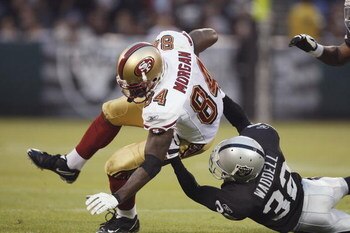 OAKLAND, CA - AUGUST 08:  Wide receiver Josh Morgan #84 of the San Francisco 49ers is tackled by defensive back Michael Waddell #32 of the Oakland Raiders on August 8, 2008 at McAfee Coliseum in Oakland, California.  (Photo by Greg Trott/Getty Images)