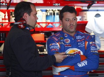 DOVER, DE - SEPTEMBER 26: Tony Stewart (R), driver of the #14 Burger King Chevrolet, talks with crew chief Darian Grubb after practice for the NASCAR Sprint Cup Series AAA 400 at Dover International Speedway on September 26, 2009 in Dover, Delaware.  (Pho