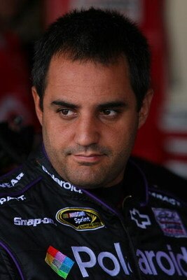 DOVER, DE - SEPTEMBER 26:  Juan Pablo Montoya, driver of the #42 Polaroid Chevrolet, stands in the garage during practice for the NASCAR Sprint Cup Series AAA 400 at Dover International Speedway on September 26, 2009 in Dover, Delaware.  (Photo by Chris T