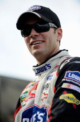 DOVER, DE - SEPTEMBER 25:  Jimmie Johnson, driver of the #48 Lowe's Chevrolet climbs out of his car during qualifying for the NASCAR Sprint Cup Series AAA 400 at Dover International Speedway on September 25, 2009 in Dover, Delaware.  (Photo by Jeff Zeleva
