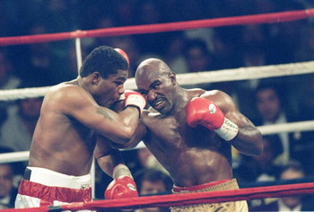 4 Nov 1995: Riddick Bowe (left) and Evander Holyfield III trade blows during a bout at Caesar''s Palace in Las Vegas, Nevada. Bowe won the fight with a technical knockout in the eighth round. Mandatory Credit: Holly Stein /Allsport