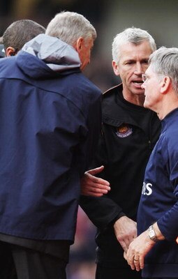 LONDON - NOVEMBER 05:  Alan Pardew (C) the West Ham United manager tries to shake hands with Arsene Wenger (L) the Arsenal manager and Pat Rice (R) the Arsenal assistant manager during the Barclays Premiership match between West Ham United and Arsenal at 