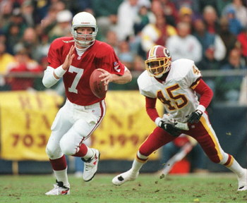 10 Nov 1996: Boomer Esiason #7 of the Arizona Cardinals runs from Washington Redskins defenders during the Cardinals 37-34 overtime win at RFK Stadium in Washington DC.