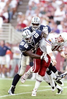 7 Sep 1997:  Quarterback Kent Graham of the Arizona Cardinals gets tackled by linebackers Dexter Coakley and Darryl Hardy of the Dallas Cowboys during a game at Sun Devil Stadium in Tempe, Arizona.  The Cardinals won the game, 25-22. Mandatory Credit: Jed
