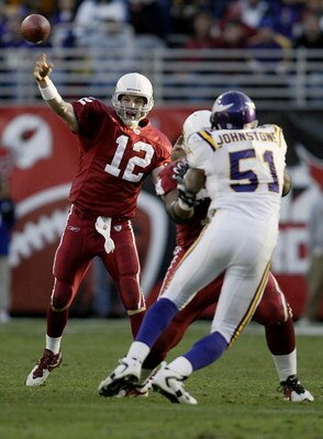 TEMPE, AZ - DECEMBER 28:  Quarterback Josh McCown #12 of the Arizona Cardinals throws a pass as teammate Reggie Wells #74 blocks Lance Johnstone #51 of the Minnesota Vikings  during their game December 28, 2003 at Sun Devil Stadium in Tempe, Arizona. The 