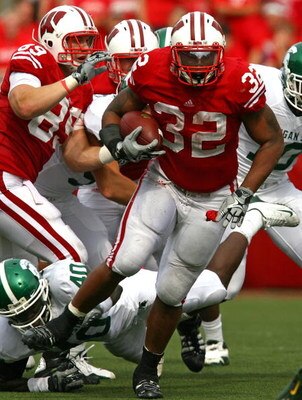 MADISON, WI - SEPTEMBER 26: John Clay #32 of the Wisconsin Badgers runs past Roderick Jenrette #40 of the Michigan State Spartans on September 26, 2009 at Camp Randall Stadium in Madison, Wisconsin. Wisconsin defeated Michigan State 38-30.  (Photo by Jona