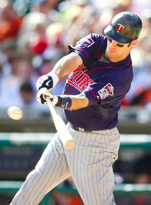 DETROIT - OCTOBER 1:  Joe Mauer #7 of the Minnesota Twins hits a run-scoring single in the eighth inning against the Detroit Tigers during the game on October 1, 2009 at Comerica Park in Detroit, Michigan. (Photo by Gregory Shamus/Getty Images)
