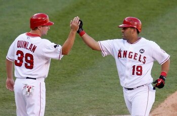 ANAHEIM, CA - OCTOBER 01:  Robb Quinlan #39 of the Los Angeles Angels of Anaheim congratulates Kendry Morales #19 after Morales' two-run home run against the Texas Rangers in the third inning at Angel Stadium on October 1, 2009 in Anaheim, California. The