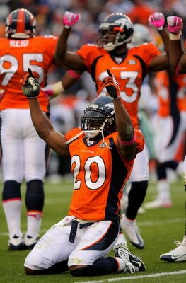 DENVER - OCTOBER 04:  Brian Dawkins #20 and Renaldo Hill #23 of the Denver Broncos celebrate after the Dallas Cowboys on fourth down with :01 second remaining in the game during NFL action at Invesco Field at Mile High on October 4, 2009 in Denver, Colora