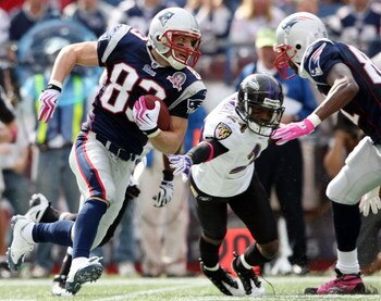 FOXBORO, MA - OCTOBER 04:  Wes Welker #83 of the New England Patriots carries the ball around Domonique Foxworth #24 of the Baltimore Ravens on October 4, 2009 at Gillette Stadium in Foxboro, Massachusetts.  (Photo by Elsa/Getty Images)