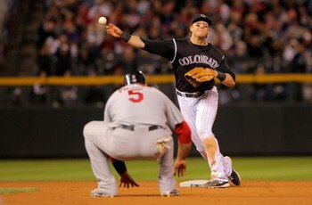 DENVER - SEPTEMBER 25:  Shortstop Troy Tulowitzki #2 of the Colorado Rockies turns a double play on Albert Pujols #5 of the St. Louis Cardinals on a grounder by Matt Holliday of the Cardinals to end the eighth inning at Coors Field on September 25, 2009 i