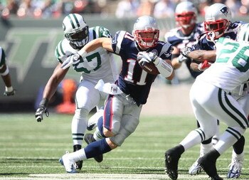 EAST RUTHERFORD, NJ - SEPTEMBER 20:  Julian Edelman #11 of the New England Patriots runs the ball against the New York Jets at Giants Stadium on September 20, 2009 in East Rutherford, New Jersey.  (Photo by Nick Laham/Getty Images)