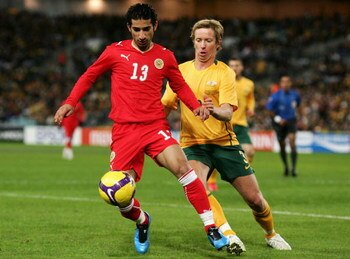 SYDNEY, AUSTRALIA - JUNE 10:  Mahmood Abdulrahman of Bahrain competes with David Carney of the Socceroos during the 2010 FIFA World Cup Asian qualifying match between the Australian Socceroos and Bahrain at ANZ Stadium on June 10, 2009 in Sydney, Australi