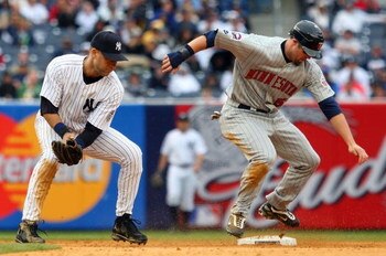 NEW YORK - MAY 17:  Michael Cuddyer #5 of the Minnesota Twins steals second base against Derek Jeter #2 of the New York Yankees on May 17, 2009 at Yankee Stadium in the Bronx borough of New York City. The Yankees defeated the Twins 3-2 in ten innings.  (P