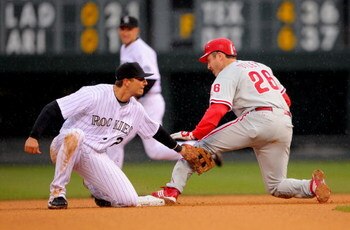 DENVER - APRIL 12:  Shortstop Troy Tulowitzki #2 of the Colorado Rockies puts a tag on Chase Utley #26 of the Philadelphia Phillies at second base at Coors Field on April 12, 2009 in Denver, Colorado. The Phillies defeated the Rockies 7-5.  (Photo by Doug