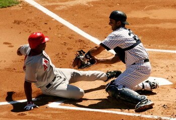 NEW YORK - AUGUST 13:  Jorge Posada #20 of the New York Yankees tags out Howie Kendrick #47 of the Los Angeles Angels of Anaheim at home plate August 13, 2006 at Yankee Stadium in the Bronx borough of New York City.  (Photo by Nick Laham/Getty Images)