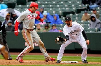 DENVER - APRIL 12:  First baseman Todd Helton #17 of the Colorado Rockies take a pick off throw as Jason Werth #28 of the Philadelphia Phillies gets back to firstbase at Coors Field on April 12, 2009 in Denver, Colorado. The Phillies defeated the Rockies 