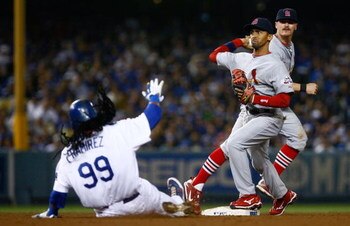 LOS ANGELES, CA - AUGUST 19:  Julio Lugo #12 of the St. Louis Cardinals forces out Manny Ramirez #99 of the Los Angeles Dodgers at second base at Dodger Stadium on August 19, 2009 in Los Angeles, California. (Photo by Jeff Gross/Getty Images)