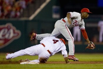 ST. LOUIS, MO - AUGUST 3: Jimmy Rollins #11 of the Philadelphia Phillies turns a double play over Yadier Molina #4 of the St. Louis Cardinals at Busch Stadium August 3, 2008 in St. Louis, Missouri.  (Photo by Dilip Vishwanat/Getty Images)