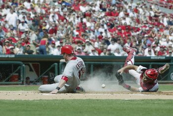 ST. LOUIS - JUNE 20:  Darin Erstad #17 of the Anaheim Angels slides safely into home plate as Mike Matheny #22 of the St. Louis Cardinals drops the ball at Busch Stadium in St. Louis, Missouri on June 20, 2002.  (Photo by Elsa/Getty Images)