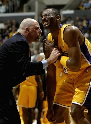 LOS ANGELES - JANUARY 12:  Trainer Gary Vitti examines an injury to the shoulder of Kobe Bryant #8 of the Los Angeles Lakers during the game against the Cleveland Cavaliers on January 12, 2004 at Staples Center in Los Angeles, California.  NOTE TO USER: U