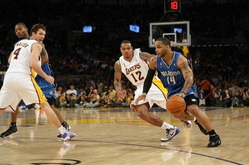 LOS ANGELES - JUNE 7:  Jameer Nelson #14 of the Orlando Magic drives against Shannon Brown #12 of the Los Angeles Lakers in Game Two of the 2009 NBA Finals at Staples Center on June 7, 2009 in Los Angeles, California.  The Lakers won 101-96 in overtime.  