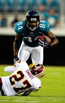 JACKSONVILLE, FL - SEPTEMBER 03:  Troy Williamson #84 of the Jacksonville Jaguars is tackled by Fred Smoot #27 of the Washington Redskins during the game at Jacksonville Municipal Stadium on September 3, 2009 in Jacksonville, Florida.  (Photo by Sam Green