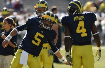 ANN ARBOR, MI - SEPTEMBER 19:  Quarterback Tate Forcier #5 of the Michigan Wolverines greets running back Brandon Minor #4 during warmups for the game against the Eastern Michigan Eagles at Michigan Stadium on September 19, 2009 in Ann Arbor, Michigan.  M