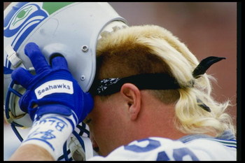 25 Oct 1987: Linebacker Brian Bosworth of the Seattle Seahawks takes off his helmet during a game against the Los Angeles Raiders at the Los Angeles Memorial Coliseum in Los Angeles, California. The Seahawks won the game, 35-13.