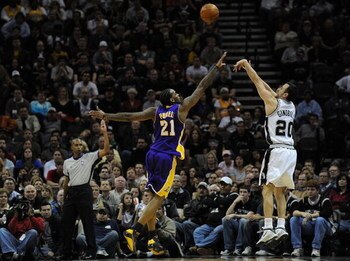 SAN ANTONIO - JANUARY 14:  Manu Ginobili #20 of the San Antonio Spurs takes a shot against Josh Powell #21 of the Los Angeles Lakers on January 14, 2009 at AT&T Center in San Antonio, Texas.  NOTE TO USER: User expressly acknowledges and agrees that, by d