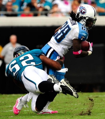 JACKSONVILLE, FL - OCTOBER 04:  Chris Johnson #28 of the Tennessee Titans is tackled by Daryl Smith # 52 of the Jacksonville Jaguars during the game at Jacksonville Municipal Stadium on October 4, 2009 in Jacksonville, Florida.  (Photo by Sam Greenwood/Ge
