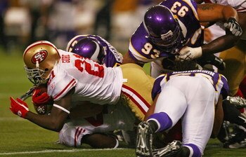 MINNEAPOLIS - SEPTEMBER 27: Frank Gore #21 of the San Francisco 49ers is tackled by Chad Greenway #52, Kevin Williams #93 and E.J. Henderson #56 of the Minnesota Vikings at the Hubert H. Humphrey Metrodome on September 27, 2009 in Minneapolis, Minnesota. 