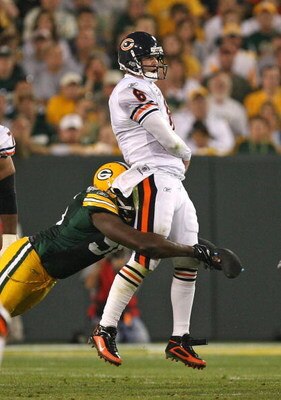 GREEN BAY, WI - SEPTEMBER 13: Jay Cutler #6 of the Chicago Bears is hit by Michael Montgomery #96 of the Green Bay Packers after passing the ball on September 13, 2009 at Lambeau Field in Green Bay, Wisconsin. The Packers defeated the Bears 21-15. (Photo 