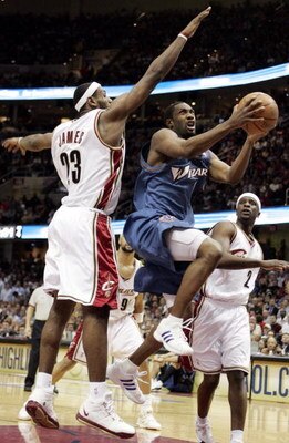 CLEVELAND - APRIL 25:  Gilbert Arenas #0 of the Washington Wizards tries to split the defense of LeBron James #23 and Flip Murray #2 of the Cleveland Cavaliers in game two of the Eastern Conference Quarterfinals during the 2006 NBA Playoffs at Quicken Loa