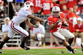 COLUMBUS, OH - OCTOBER 10:  Brandon Saine #3 of the Ohio State Buckeyes tries to elude the tackle attempt of David Gilbert #11 of the Wisconsin Badgers at Ohio Stadium on October 10, 2009 in Columbus, Ohio.  (Photo by Jamie Sabau/Getty Images)