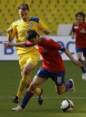 MOSCOW, RUSSIA - APRIL 26: Alan Dzagoev (R) of PFC CSKA Moscow battles for the ball with Mikhail Rozhkov of FC Rostov during the Russian Football League Championship match between PFC CSKA and FC Rostov at the Luzhniki Stadium on April 26, 2009 in Moscow,
