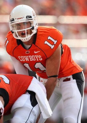 STILLWATER, OK - SEPTEMBER 05:  Quarterback Zac Robinson #11 of the Oklahoma State Cowboys snaps the ball during the college football game against the Georgia Bulldogs at Boone Pickens Stadium on September 5, 2009 in Stillwater, Oklahoma.  The Cowboys def