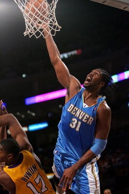 LOS ANGELES, CA - MAY 19:  Nene #31 of the Denver Nuggets goes up for a dunk over Andrew Bynum #17 of the Los Angeles Lakers in Game One of the Western Conference Finals during the 2009 NBA Playoffs at Staples Center on May 19, 2009 in Los Angeles, Califo