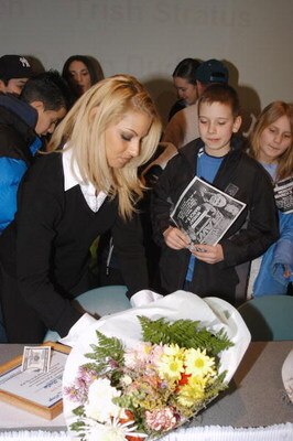 GARDEN CITY, NY - MARCH 3:  World Wrestling Entertainment (WWE) professional wrestler Trish Stratus (L) signs autographs during the 'Professor For A Day' event at Nassau Community College March 3, 2003 in Garden City, New York. Stratus acted as an assista