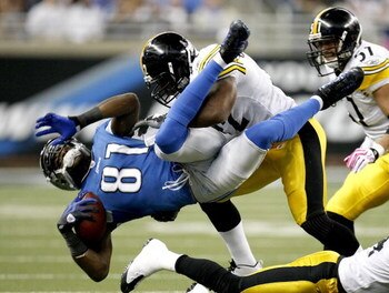 DETROIT , MI - OCTOBER 11:  Calvin Johnson #81 of the Detroit Lions is tackled by James Harrison #92 of the  Pittsburgh Steelers October 11, 2009 at Ford Field in Detroit, Michigan. Johnson was injured on the play.  (Photo by Gregory Shamus/Getty Images)